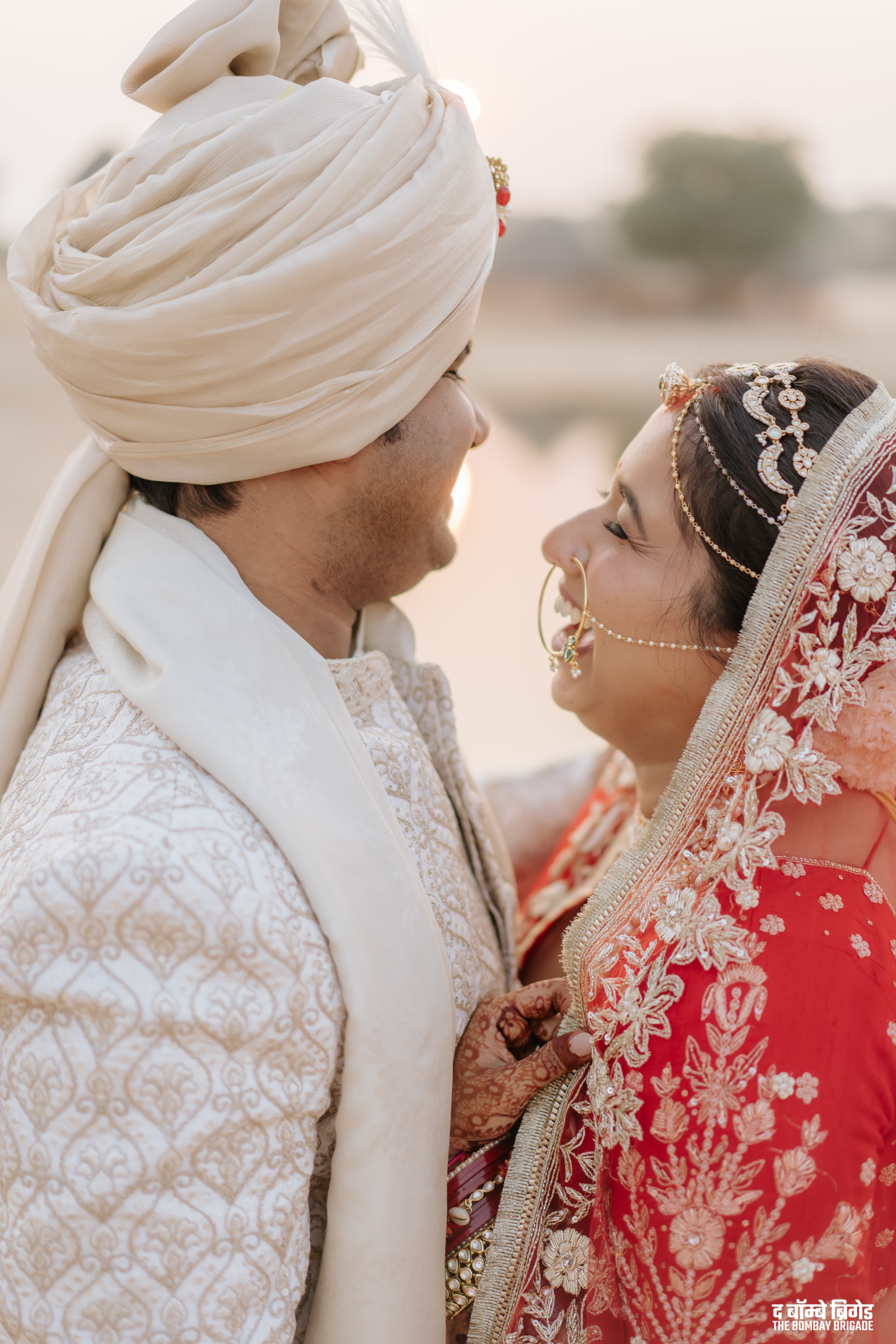 Bride and groom in traditional wedding attire sharing a quiet moment