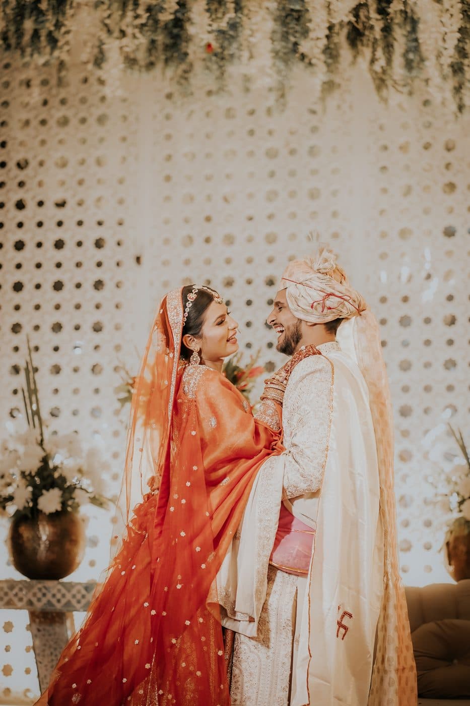 The bride and groom laughing together, face to face